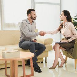 female-psychiatrist-and-patient-shaking-hands-in-office.jpg